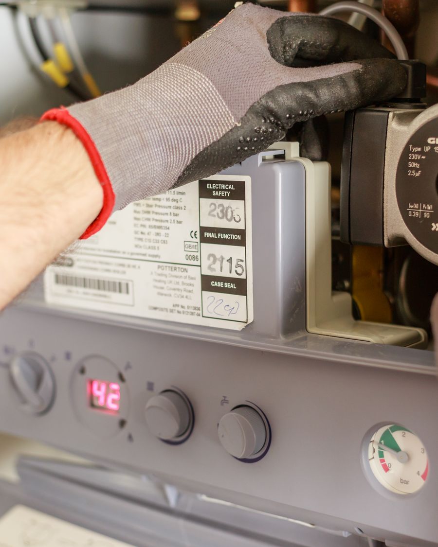 Gas Safe engineer servicing a combi boiler in Cambridge